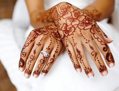 Bride's hands decorated with elaborate henna after Mehendi ceremony.