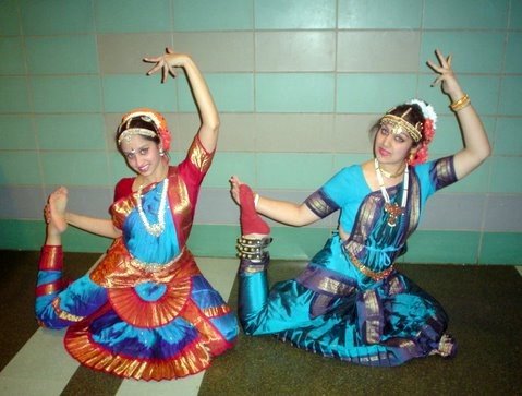 Two dancers are posing in the Bharatanatyam dance form, one of the oldest and most widely performed classical Indian dance styles.