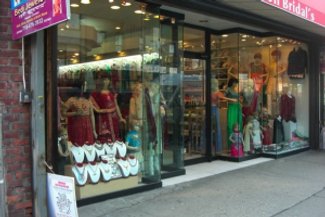 Bridal shops such as this are very common in Jackson Heights. The glamour and glitz of many of these traditional outfits attracts a diverse customer base who are new to these fashion styles. Many clothing stores owners will employ individuals based on the cultural capital they bring to the job, which includes knowledge of the latest fashion trends.