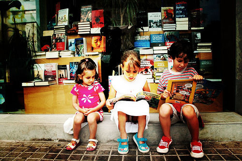 South Asian children reading outside of a bookstore in Jackson Heights. Image (c) http://idealistnyc.wordpress.com/2008/07/08/good-in-the-hood-jackson-heights-queens/