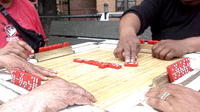 Dominoes being played in a small park in the Bronx
