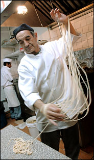     A chef spinning dough for a Bukharian dish at Shalom Restaurant. 