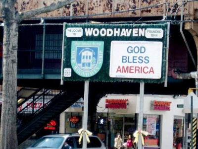 Welcome signage at Woodhaven Blvd under J & Z elevated train tracks on Jamaica Avenue.