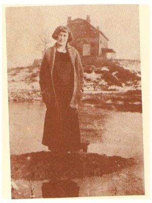 Photograph of Elise Marsilia standing before the Dewitt Clinton house. It was converted to a tenement house in the 1920s. As seen in the photograph, it was stripped of its verandas and decorative aspects. .