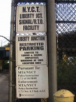 The signs in front of the tall brick building.
